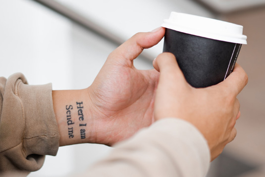 man holding compostable coffee cup